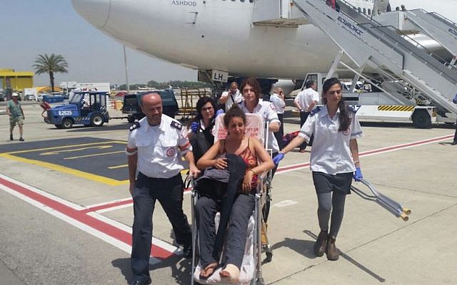 Magen David Adom medics escort an Israeli woman who flew to Israel in an emergency flight from Nepal following the earthquake there, at Ben Gurion Airport on Tuesday, April 28, 2015 (photo credit: MDA) Magen David Adom medics escort an Israeli woman who flew to Israel in an emergency flight from Nepal following the earthquake there, at Ben Gurion Airport on Tuesday, April 28, 2015 (photo credit: MDA)