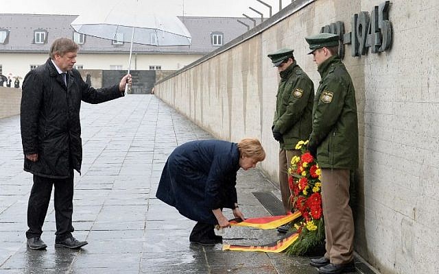 German Chancellor Angela Merkel lays a wreath at the International Memorial of former Nazi concentration camp of Dachau, southwestern Germany, during a ceremony to mark 70 years since it was liberated by US forces on May 3, 2015. American army trucks rolled into Dachau, northwest of Munich, on April 29, 1945 to discover the unspeakable horror that had led to more than 41,000 people being killed, having starved or died of disease. (photo credit: AFP PHOTO / CHRISTOF STACHE) German Chancellor Angela Merkel lays a wreath at the International Memorial of former Nazi concentration camp of Dachau, southwestern Germany, during a ceremony to mark 70 years since it was liberated by US forces on May 3, 2015. American army trucks rolled into Dachau, northwest of Munich, on April 29, 1945 to discover the unspeakable horror that had led to more than 41,000 people being killed, having starved or died of disease. (photo credit: AFP PHOTO / CHRISTOF STACHE)