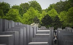 Visitors walk past concrete steles forming the Memorial to the Murdered Jews of Europe on May 5, 2015 in Berlin (AFP PHOTO / ODD ANDERSEN)