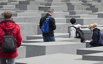 Tourists visit the Memorial to the Murdered Jews of Europe, the Holocaust Memorial, in Berlin, April 30, 2015. (photo credit: AFP/JOHN MACDOUGALL)
