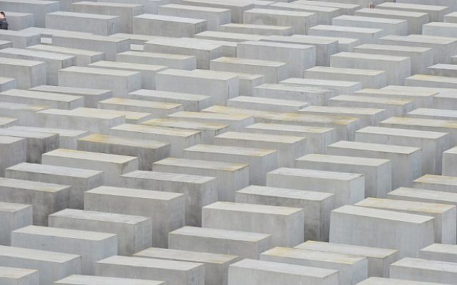A couple takes a selfie at the Murdered Jews of Europe, the Holocaust Memorial, in Berlin on April 30, 2015. (photo credit: AFP/JOHN MACDOUGALL) 
