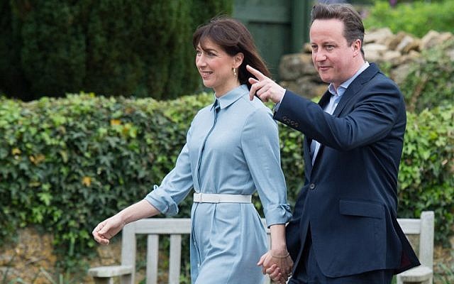 British Prime Minister and leader of the Conservative party David Cameron arrives with his wife Samantha to vote at a polling station in Spelsbury on May 7, 2015 as Britain holds a general election. (photo credit: AFP / LEON NEAL) British Prime Minister and leader of the Conservative party David Cameron arrives with his wife Samantha to vote at a polling station in Spelsbury on May 7, 2015 as Britain holds a general election. (photo credit: AFP / LEON NEAL)