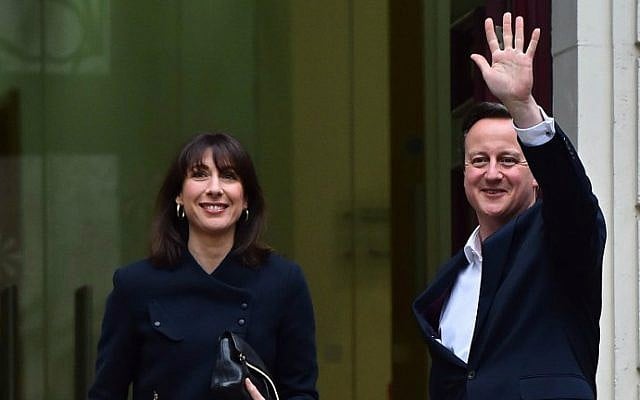 British Prime Minister David Cameron (R) and his wife Samantha arrive at Conservative Party headquarters in London on May 8, 2015, the day after a general election. (AFP Photo/Ben Stansall)