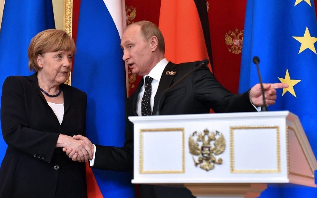 Russian President Vladimir Putin (R) shows the way to German Chancellor Angela Merkel as they leave a hall after a joint press conference at the Kremlin in Moscow on May 10, 2015. (photo credit: AFP PHOTO / KIRILL KUDRYAVTSEV) Russian President Vladimir Putin (R) shows the way to German Chancellor Angela Merkel as they leave a hall after a joint press conference at the Kremlin in Moscow on May 10, 2015. (photo credit: AFP PHOTO / KIRILL KUDRYAVTSEV)