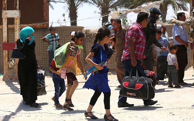In this Saturday, May 16, 2015 photo, Iraqis fleeing from their hometown of Ramadi, Iraq, walk on a street near the Bzebiz bridge, 65 kilometers (40 miles) west of Baghdad. (AP Photo/Hadi Mizban) In this Saturday, May 16, 2015 photo, Iraqis fleeing from their hometown of Ramadi, Iraq, walk on a street near the Bzebiz bridge, 65 kilometers (40 miles) west of Baghdad. (AP Photo/Hadi Mizban)
