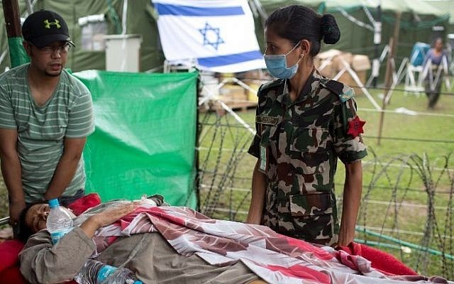 An injured Nepalese woman arrives on stretcher to be treated at the Israeli field hospital in Kathmandu on May 1, 2015, following a 7.8 magnitude earthquake which struck the Himalayan nation on April 25 (AFP PHOTO / MENAHEM KAHANA) An injured Nepalese woman arrives on stretcher to be treated at the Israeli field hospital in Kathmandu on May 1, 2015, following a 7.8 magnitude earthquake which struck the Himalayan nation on April 25 (AFP PHOTO / MENAHEM KAHANA)