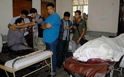Relatives of deceased Bangladeshi blogger Ananta Bijoy Das react after seeing his body in Sylhet on May 12, 2015. (photo credit: AFP)