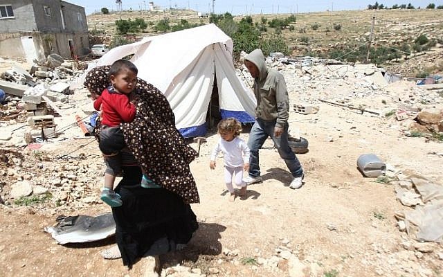 A Palestinian family whose house was demolished by Israeli bulldozers walk past a tent on April 21, 2015, in the southern West Bank village of Ad-Deirat Rifaiyya. (Hazem Bader/AFP) A Palestinian family whose house was demolished by Israeli bulldozers walk past a tent on April 21, 2015, in the southern West Bank village of Ad-Deirat Rifaiyya. (Hazem Bader/AFP)