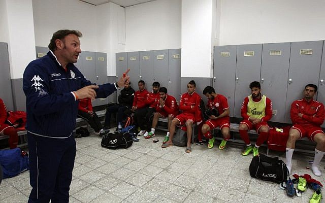 Ahli al-Khalil football club's coach, Italian Stefano Cusin talks to his players in the cloakrooms during a training session on April 24, 2015 in the West Bank town of Hebron.  (photo credit: AFP PHOTO / HAZEM BADER)