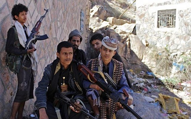 Yemeni armed men from the Popular Resistance Committees loyal to Yemen's fugitive President Abedrabbo Mansour Hadi sit under the shade on a street in the city of Taez during ongoing clashes with Shiite Huthi rebels, on May 3, 2015. (photo credit: AFP/ABDEL RAHMAN ABDALLAH/STR) Yemeni armed men from the Popular Resistance Committees loyal to Yemen's fugitive President Abedrabbo Mansour Hadi sit under the shade on a street in the city of Taez during ongoing clashes with Shiite Huthi rebels, on May 3, 2015. (photo credit: AFP/ABDEL RAHMAN ABDALLAH/STR)