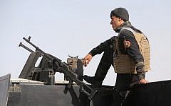A member of the Iraqi interior ministry's anti-terrorism forces stands guard on a vehicle near Anbar province's capital Ramadi, on May 8, 2015. The city, including government headquarters therein, were taken over by Islamic State on Friday, May 15 2015, according to reports. (Photo credit: Ahmad al-Rubaye/AFP)