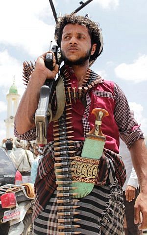 An armed Yemeni tribesman stands in the southern city of Taez as they gather to mobilize support and declare to join fighters loyal Yemen's Saudi-backed President Abedrabbo Mansour Hadi in the battle against Shiite Huthi rebels. on May 9, 2015. (Photo credit: Abdul Rahamn Alballh/AFP) 