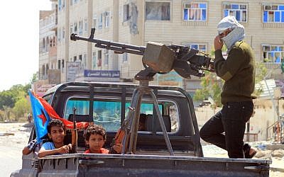 File photo: Yemeni children holding rifles sit in the back of a heavily armed pick up truck with fighters loyal to Yemen's Saudi-backed President Abd Rabbo Mansour Hadi in the Dar Saad neighborhood of the southern Yemeni city of Aden on May 10, 2015, as they continue to battle Shiite Houthi rebels. (AFP/Saleh Al-Obeidi)