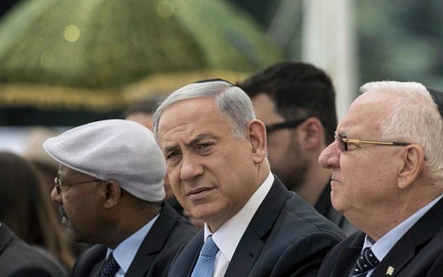 Prime Minister Benjamin Netanyahu (C) and President Reuven Rivlin (R) attend a ceremony on Mount Herzl in Jerusalem commemorating Ethiopian Jews who died attempting to immigrate to Israel, May 17, 2015. (AFP/Baz Ratner, Pool) Prime Minister Benjamin Netanyahu (C) and President Reuven Rivlin (R) attend a ceremony on Mount Herzl in Jerusalem commemorating Ethiopian Jews who died attempting to immigrate to Israel, May 17, 2015. (AFP/Baz Ratner, Pool)