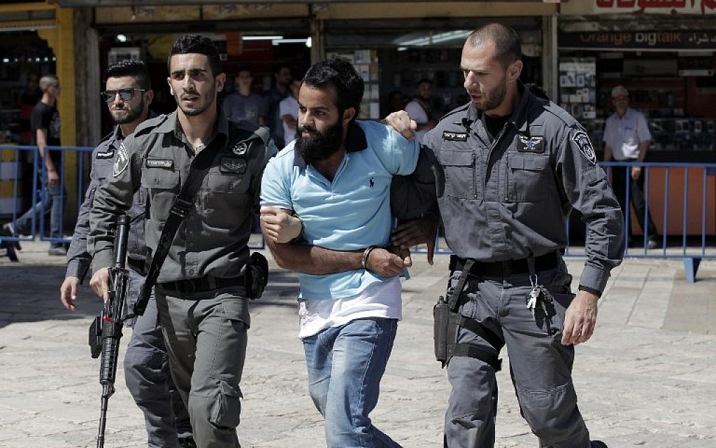 A Palestinian demonstrator is detained by Israeli police during the "flag march" through Damascus Gate in Jerusalem's Old City during celebrations for Jerusalem Day on May 17, 2015. (AFP Photo/Jack Guez)