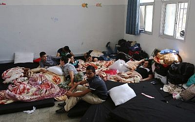 Palestinian refugees from Syria's Yarmouk refugee camp sit on mattresses inside a school as they prepare for their official exams for the 9th grade in the capital Damascus, on May 20, 2015. (AFP/Youssef Karwashan)
