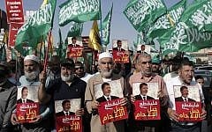 Leader of the radical northern wing of the Islamic Movement in Israel, Sheikh Raed Salah (center) attends a demonstration organized by the movement against the death sentence handed to Egypt's ousted president Mohamed Morsi, in the town of Kfar Kana, in northern Israel, on May 23, 2015. (AFP/ AHMAD GHARABLI)