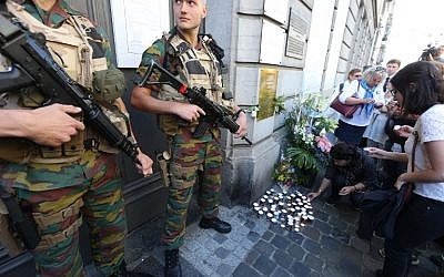 People lay down candles as soldiers stand guard at the entrance of the Jewish museum in Brussels, on 24, May 2015. (Nicolas Maeterlinck/AFP) People lay down candles as soldiers stand guard at the entrance of the Jewish museum in Brussels, on 24, May 2015. (Nicolas Maeterlinck/AFP)