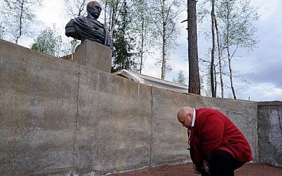 A man bows during the inauguration of a sculpture of Russian President Vladimir Putin in the village of Agalatovo about 30 km from Saint Petersburg, May 16, 2015. (AFP/OLGA MALTSEVA)