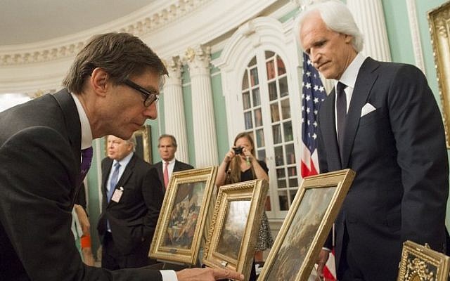 Germany's Ambassador to the US Peter Wittig (L), looks at five paintings that were to be returned to Germany in cooperation with the Monuments Men Foundation, during a ceremony at the State Department in Washington, DC, May 5, 2015. (AFP/SAUL LOEB) Germany's Ambassador to the US Peter Wittig (L), looks at five paintings that were to be returned to Germany in cooperation with the Monuments Men Foundation, during a ceremony at the State Department in Washington, DC, May 5, 2015. (AFP/SAUL LOEB)