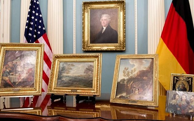 Five paintings (on table) that were be returned to Germany in cooperation with the Monuments Men Foundation, during a ceremony at the State Department in Washington, DC, May 5, 2015. (photo credit: AFP/SAUL LOEB) 