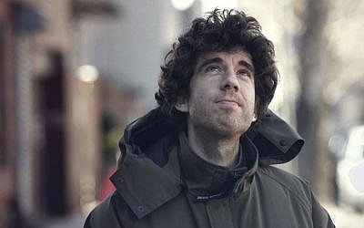 Daniel Koren bundles up against the cold in Williamsburg, Brooklyn. (Photo credit: Judah Ari Gross/Times of Israel)