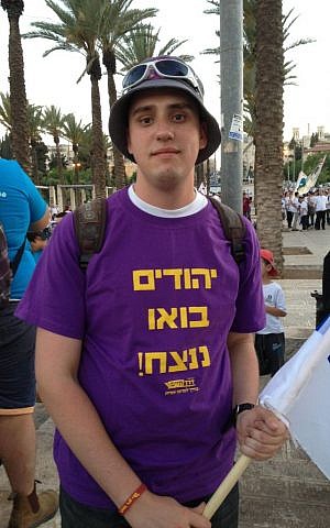 Vlad, 20, wears a t-shirt reading "Jews, let's win!" (Elhanan Miller/Times of Israel) 