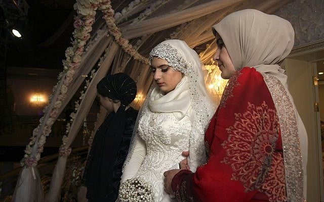 Chechen Kheda Goilabiyeva, second right, stands after her wedding with Chechen police officer Nazhud Guchigov, in Chechnya's provincial capital Grozny, Russia, Saturday, May 16, 2015. (AP Photo) Chechen Kheda Goilabiyeva, second right, stands after her wedding with Chechen police officer Nazhud Guchigov, in Chechnya's provincial capital Grozny, Russia, Saturday, May 16, 2015. (AP Photo)