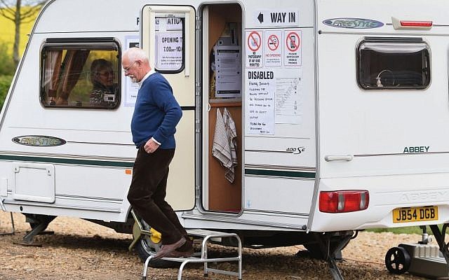 A man leaves after casting his vote in a caravan used as a polling station on Grange Farm in Garthorpe, England, Thursday May 7, 2015 (photo credit: Joe Giddens / PA via AP) A man leaves after casting his vote in a caravan used as a polling station on Grange Farm in Garthorpe, England, Thursday May 7, 2015 (photo credit: Joe Giddens / PA via AP)