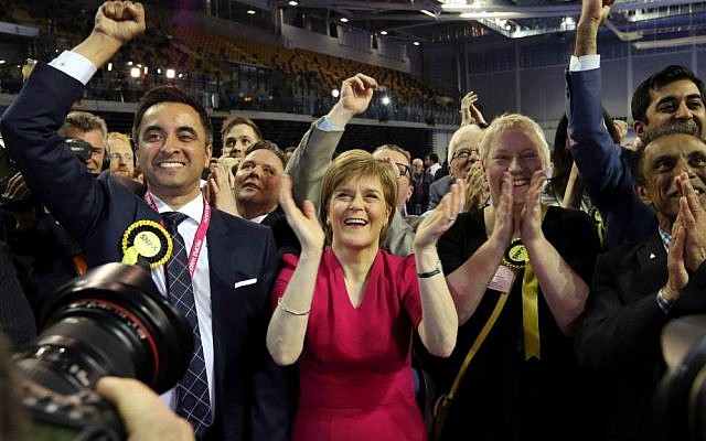 First Minister of Scotland and Scottish National Party leader Nicola Sturgeon, second left, celebrates with the results for her party at the count of Glasgow constituencies for the General Election, Glasgow, Scotland, Friday, May 8, 2015. (AP Photo/Scott Heppell)