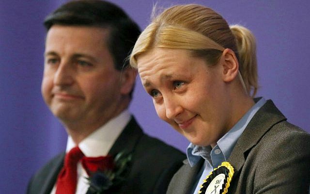 Paisley and Renfrewshire South constituency winner Mhairi Black of the Scottish National Party (SNP) and Labour's Douglas Alexander react at the Lagoon Leisure Centre in Paisley, Scotland, Friday May 8, 2015. Black, a 20-year-old student, becomes Britain's youngest lawmaker since the 17th century. (David Cheskin/PA via AP) Paisley and Renfrewshire South constituency winner Mhairi Black of the Scottish National Party (SNP) and Labour's Douglas Alexander react at the Lagoon Leisure Centre in Paisley, Scotland, Friday May 8, 2015. Black, a 20-year-old student, becomes Britain's youngest lawmaker since the 17th century. (David Cheskin/PA via AP)