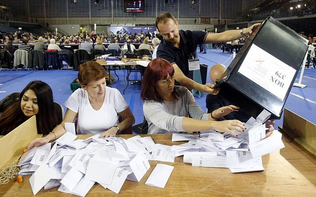 The first votes arrive at the general election count for the Glasgow constituencies at the Emirates Arena in Glasgow, Scotland, May 7, 2015. (photo credit: Danny Lawson/PA via AP) The first votes arrive at the general election count for the Glasgow constituencies at the Emirates Arena in Glasgow, Scotland, May 7, 2015. (photo credit: Danny Lawson/PA via AP)