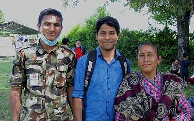 Pushkar Bishwokarma (center), outside the Nepali field hospital where he tried to volunteer. He is with his cousin Deness Bishwokarma (left), who is stationed at the hospital, and his mother, Sarada Bishwokarma. May 2015. (photo credit: Melanie Lidman/Times of Israel)