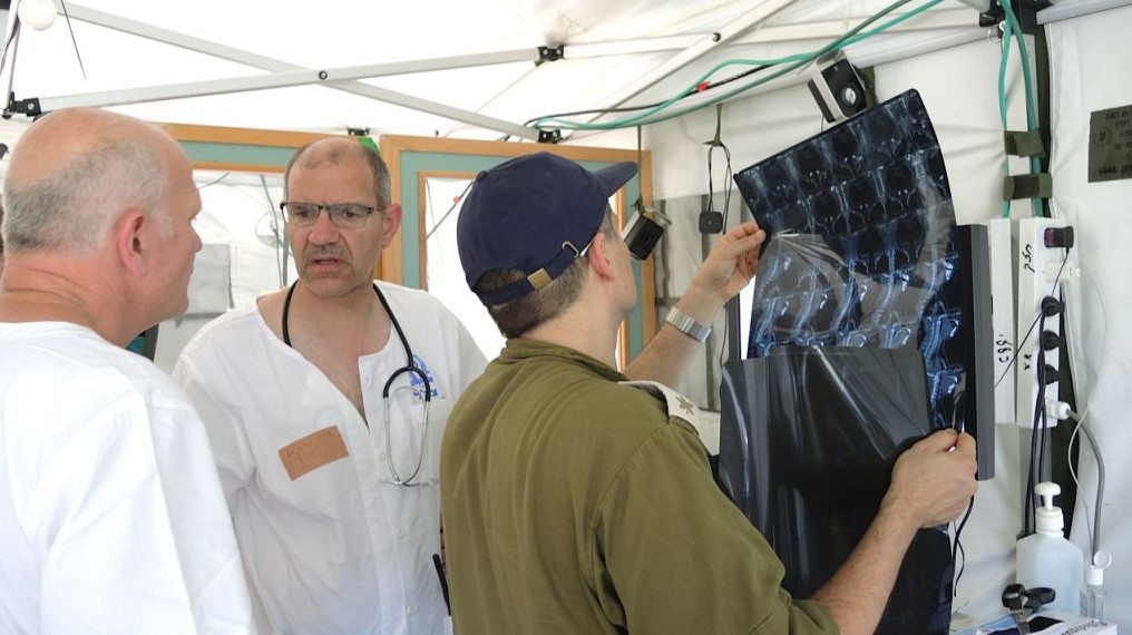Israeli doctors examine X-rays of a patients’ pelvis at the IDF field hospital in Kathmandu (Photo credit: Melanie Lidman) Israeli doctors examine X-rays of a patients’ pelvis at the IDF field hospital in Kathmandu (Photo credit: Melanie Lidman)