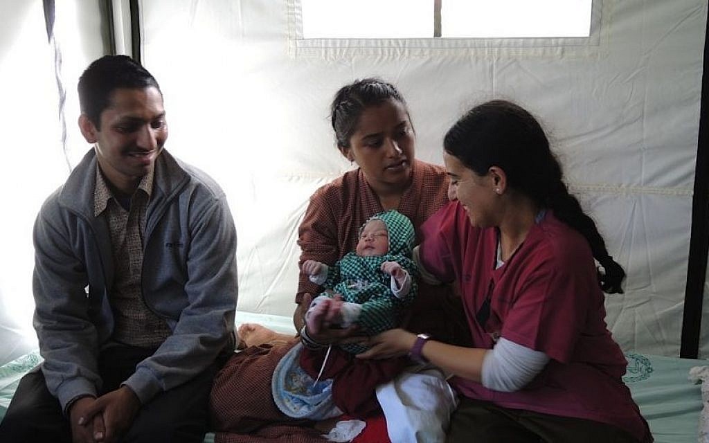 Israeli midwife Dganit Gery sits with Lata and Harendra Chang, whose baby was delivered at the IDF field hospital in Kathmandu on Friday, May 1, 2015. (Photo credit: Melanie Lidman) Israeli midwife Dganit Gery sits with Lata and Harendra Chang, whose baby was delivered at the IDF field hospital in Kathmandu on Friday, May 1, 2015. (Photo credit: Melanie Lidman)