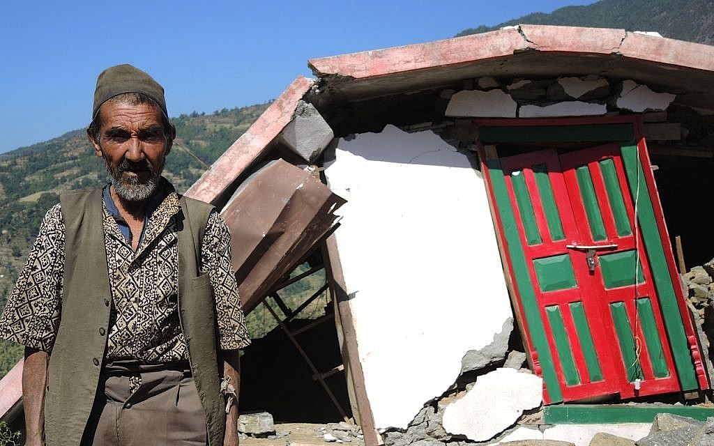 A man stands outside the ruins of his home a two hour walk from Topani, in the Sidhulpalchowk district, seven hours away from Kathmandu, Nepal. May 2015. (photo credit: Melanie Lidman / Times of Israel)