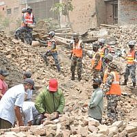 Nepali army soldiers and employees from the local tourism department clear the rubble in Durbar Square in Bakhtapur. Two weeks after the first earthquake, the square looked much cleaner than other damaged areas due to the vigilant work of residents, volunteers, and officials to clean the heritage site. (Melanie Lidman/Times of Israel)