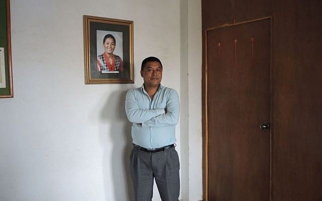 Bachchu N. Shrestha, the director of the Pasang Lhamu Sherpa Foundation and World Expeditions Trekking Company, stands next to a photo of Pasang Lhamu Sherpa, the first Nepali woman to summit Everest. Shrestha urges all Nepal lovers to come visit the country now, when it most needs the support of international tourists. (Melanie Lidman/Times of Israel)