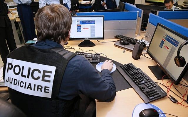 A French police officer working at the headquarters of the Pharos reporting platform against cyber criminality, in Nanterre, outside Paris, January 19, 2015. (AP/Patrick Kovarik, pool, File) A French police officer working at the headquarters of the Pharos reporting platform against cyber criminality, in Nanterre, outside Paris, January 19, 2015. (AP/Patrick Kovarik, pool, File)