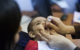 Illustrative - A child being vaccinated at a children's medical center in Neve Yaakov, Jerusalem, September 10, 2013. (Yonatan Sindel/Flash90)