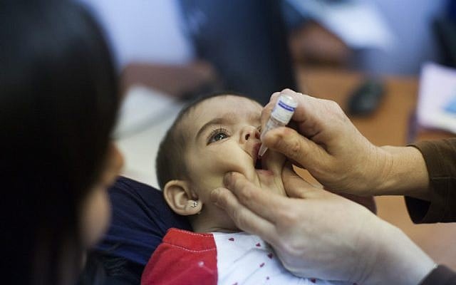 Illustrative - A child being vaccinated at a children's medical center in Neve Yaakov, Jerusalem, September 10, 2013. (Yonatan Sindel/Flash90) Illustrative - A child being vaccinated at a children's medical center in Neve Yaakov, Jerusalem, September 10, 2013. (Yonatan Sindel/Flash90)