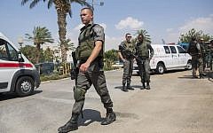 File photo: Police and rescue personnel at the scene where an Israeli security guard at the entrance to Ma’ale Adumim, outside of Jerusalem, was stabbed by an attacker who fled into a nearby Arab village, August 2014. (Photo credit: Yonatan Sindel/FLASH90)