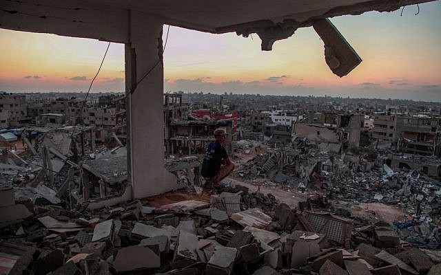 A man sits in a destroyed house in Al Shejaeiya neighborhood in the east of Gaza City, August 28, 2014 (photo credit: Emad Nassar/Flash90)
