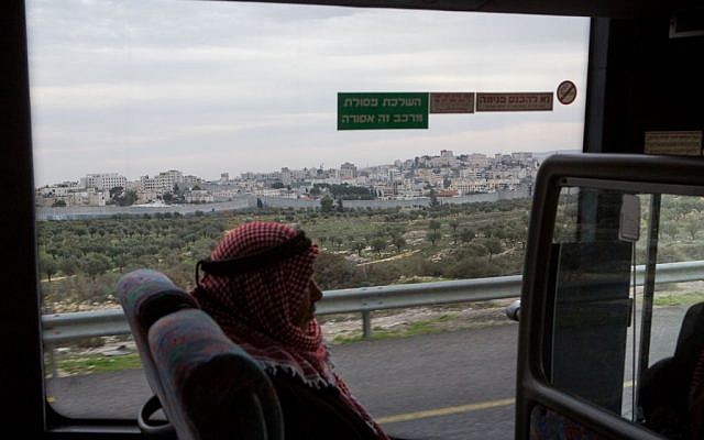 A Palestinian man rides the bus near the city of Bethlehem, December 18, 2014 (Miriam Alster/Flash90) A Palestinian man rides the bus near the city of Bethlehem, December 18, 2014 (Miriam Alster/Flash90)