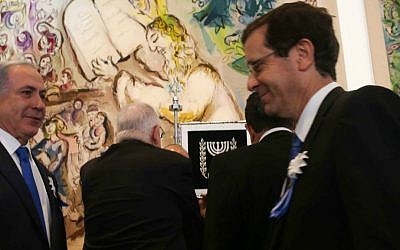 Prime Minister Benjamin Netanyahu shakes hands with leader of the opposition Isaac Herzog during the opening session of the Knesset on March 31, 2015. (Nati Shohat/Flash90) Prime Minister Benjamin Netanyahu shakes hands with leader of the opposition Isaac Herzog during the opening session of the Knesset on March 31, 2015. (Nati Shohat/Flash90)