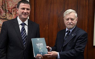 State Comptroller Yosef Shapira (R) hands the State Comptroller's report to chairman of the Israeli parliament Yuli Edelstein in the Knesset on May 05, 2015. (Photo credit: Isaac Harari/ Flash90) 