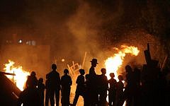 Ultra-Orthodox Jews gather around a bonfire during celebrations of the Jewish holiday of Lag B'Omer in Bnei Brak on May 6, 2015. (Yaakov Naumi/Flash90)