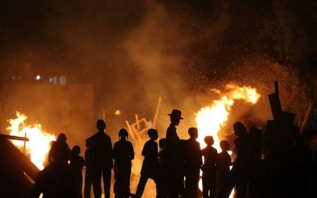 Ultra-Orthodox Jews gather around a bonfire during celebrations of the Jewish holiday of Lag B'Omer in Bnei Brak on May 6, 2015. (Yaakov Naumi/Flash90)