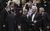 Prime Minister Benjamin Netanyahu (center) seen with other members of Knesset, after a Knesset vote on enabling an increase in the number of government ministers, May 11, 2015. (photo credit: Miriam Alster/Flash90)