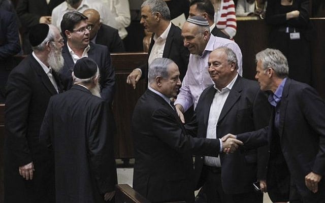Prime Minister Benjamin Netanyahu (center) seen with other members of Knesset, after a Knesset vote on enabling an increase in the number of government ministers, May 11, 2015. (photo credit: Miriam Alster/Flash90) Prime Minister Benjamin Netanyahu (center) seen with other members of Knesset, after a Knesset vote on enabling an increase in the number of government ministers, May 11, 2015. (photo credit: Miriam Alster/Flash90)